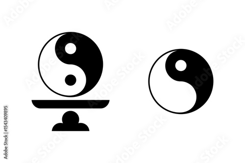 Two yin yang symbols one on a stand black and white