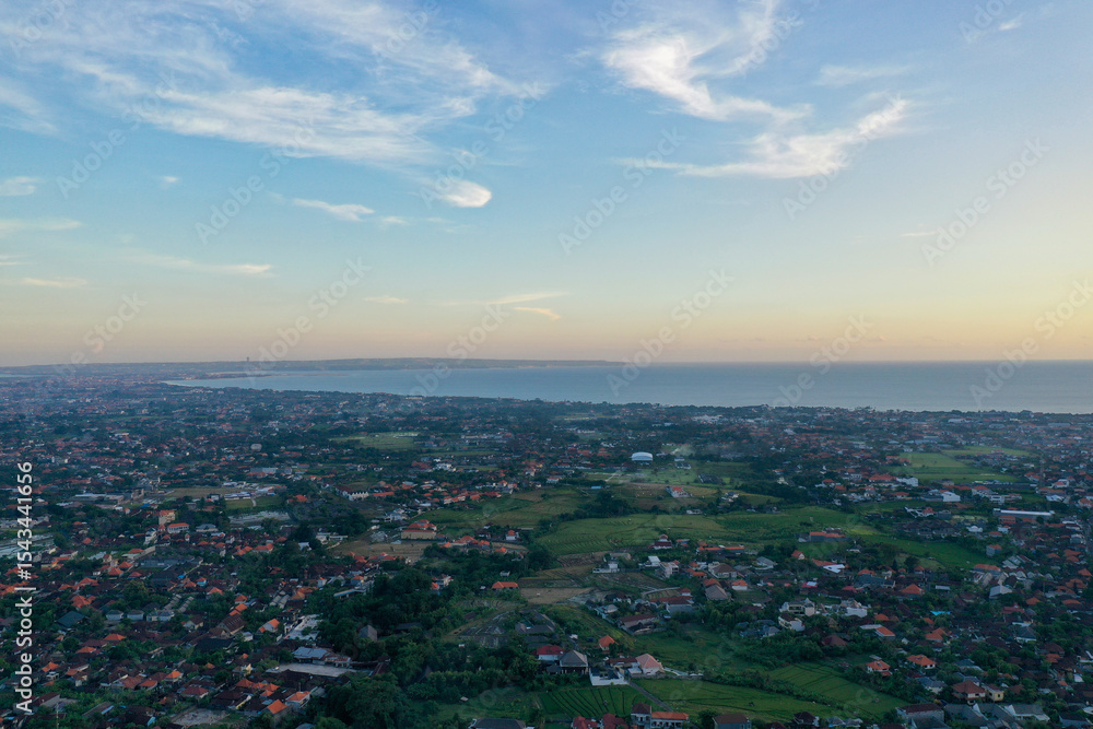 Fototapeta premium Sunset Panorama of Balinese Homes with Ocean View