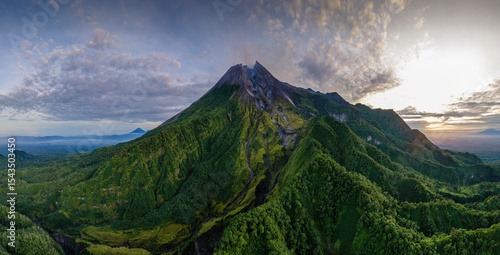 Foto Sunrise Over Mount Merapi – Aerial View of Active Volcano, Indonesia