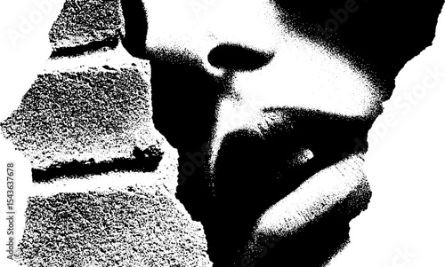 High contrast graffiti art on brick wall featuring abstract face design