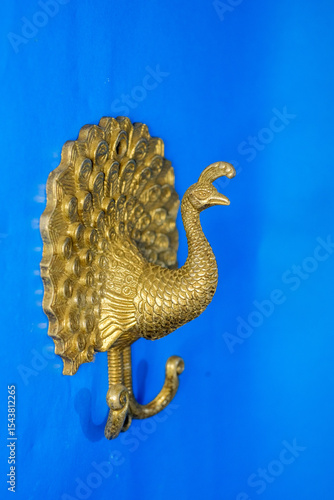 Photography Handcrafted Vintage Brass Peacock Figurine with Intricate Feather Details on Blu