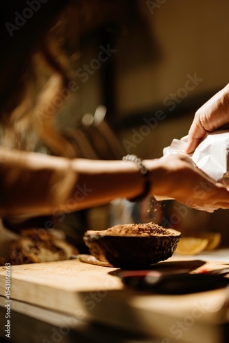 Wallpaper Mural A pastry chef delicately sprinkles flour and colorful toppings over cozonac preparations in a cozy kitchen, showcasing the magic of traditional baking and food styling techniques Torontodigital.ca
