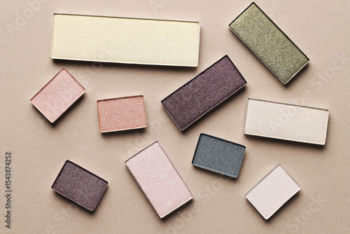 Tableau sur toile Beautiful eyeshadow refill pans on beige background, flat lay
