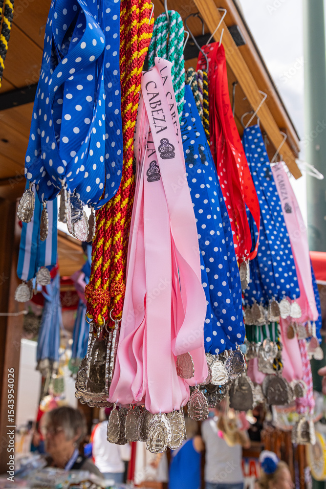 Fototapeta premium Andujar, Jaen Province, Andalusia, Spain. Religious medallions for sale at the annual pilgrimage for the Virgen de la Cabeza, Our Lady of Cabeza.