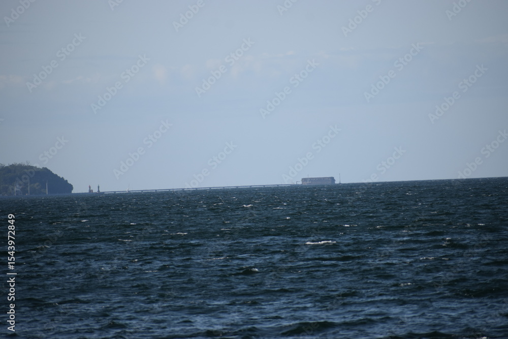 in the photo the sea in the background the shore with buildings in the photo the sea in the background the shore with buildings