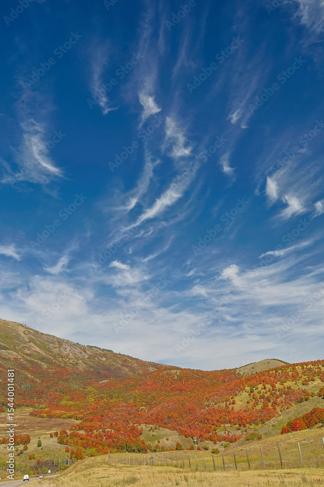 USA, Utah. East of Brigham City near Wellsville with mountain range covered in canyon maple in reds of fall color. USA, Utah. East of Brigham City near Wellsville with mountain range covered in canyon maple in reds of fall color.