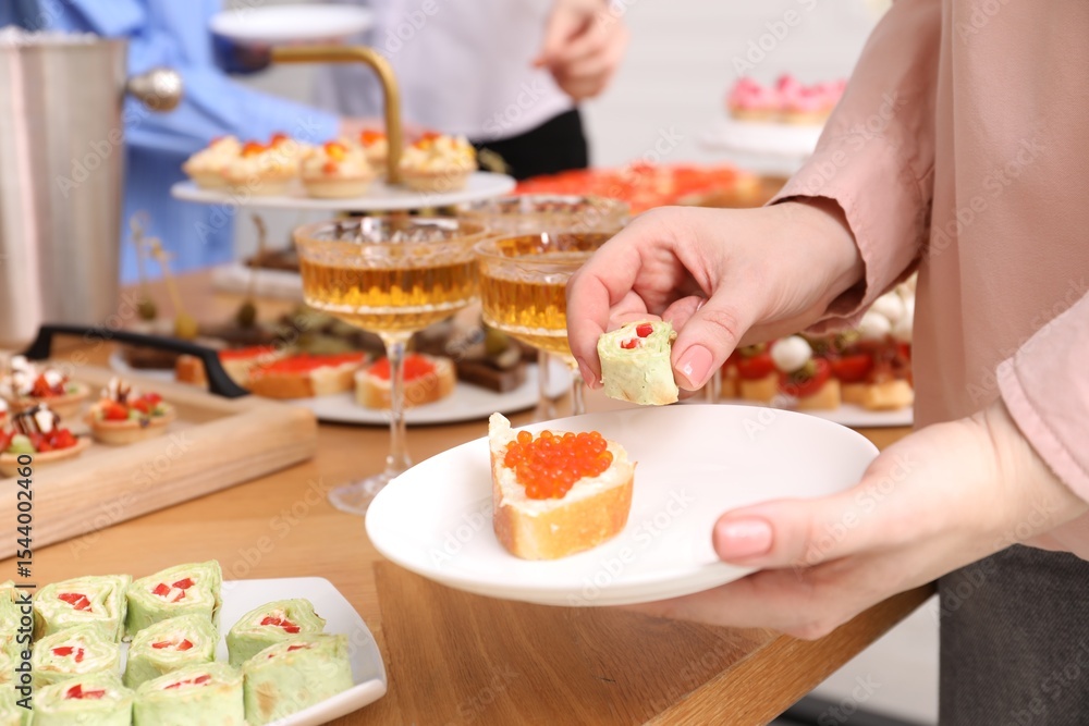 Buffet menu. Woman taking tasty appetizers from table, closeup Buffet menu. Woman taking tasty appetizers from table, closeup