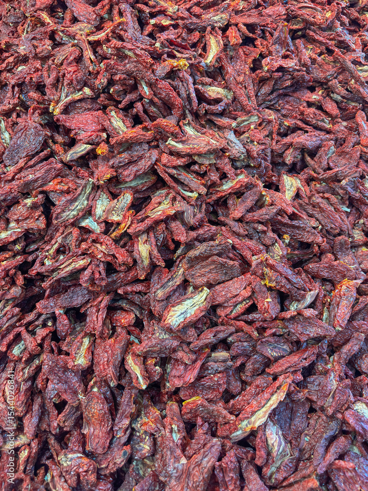 Fototapeta premium A close up, full frame view of a large pile of sun dried tomatoes, concept of italian cuisine, healthy food, ingredient