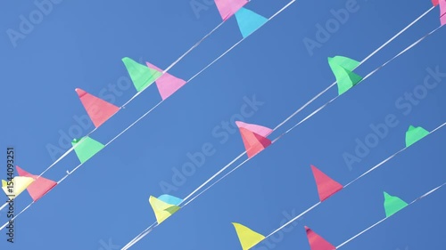 multicolored flags on a blue sky background