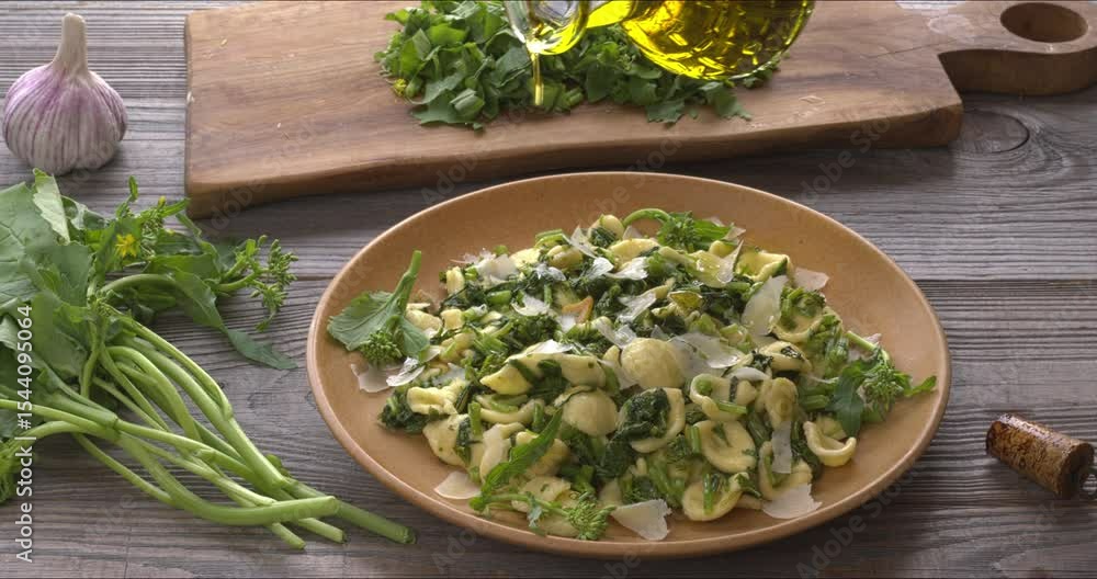 Pouring olive oil over orecchiette pasta with homegrown broccoli rabe (rapini). Rapini is a rich source of vitamin K. Pouring olive oil over orecchiette pasta with homegrown broccoli rabe (rapini). Rapini is a rich source of vitamin K.