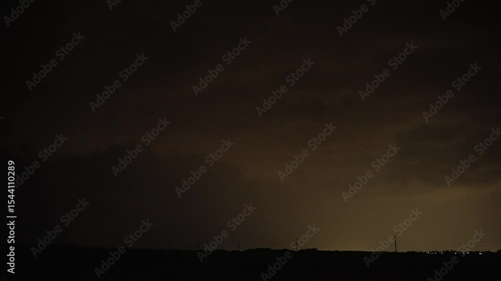 Multiple Lightning Flashes Strike From Dark Storm Cloud Over Rural Horizon at Night Multiple Lightning Flashes Strike From Dark Storm Cloud Over Rural Horizon at Night
