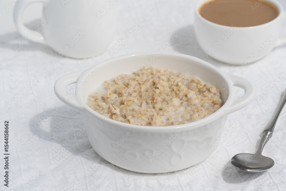 Oatmeal porridge in white bowl, close up view Oatmeal porridge in white bowl, close up view
