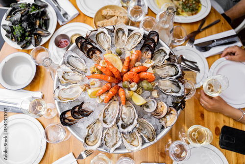 A delectable seafood platter featuring an array of fresh oysters, shrimp, and mussels, perfect for dining.