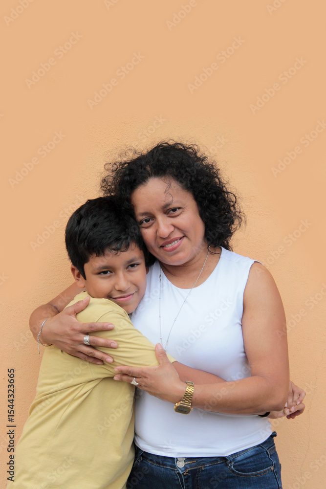 A divorced single mother and her 9-year-old Latino son show their love with hugs and kisses to celebrate Mother's Day A divorced single mother and her 9-year-old Latino son show their love with hugs and kisses to celebrate Mother's Day