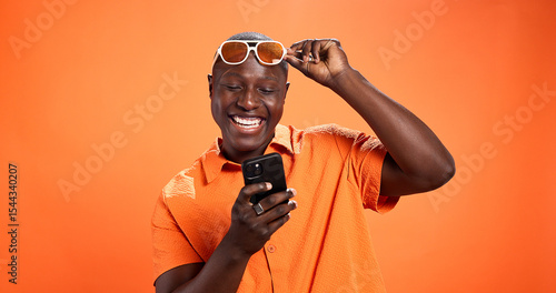 фотографія Excited, fashion or black man with phone in studio for surprise discount, sale or bargain deal