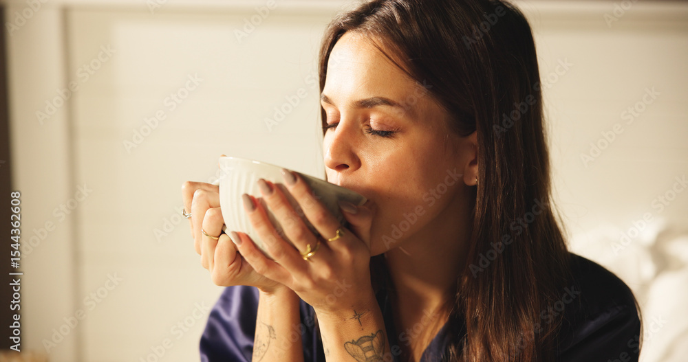 Woman, drinking and coffee on bed at house for morning start, enjoy espresso and smell aroma. Female person, thinking and beverage for peace, nostalgia memories and herbal tea for wellness in bedroom Woman, drinking and coffee on bed at house for morning start, enjoy espresso and smell aroma. Female person, thinking and beverage for peace, nostalgia memories and herbal tea for wellness in bedroom