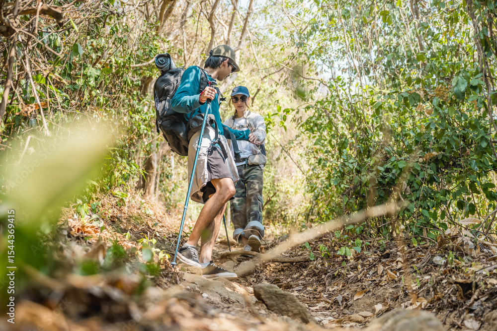 Naklejka premium Asian couple hiking forest trail. Hiker lifestyles activity. Hike trekking backpacker. Backpacker trekking outdoors.