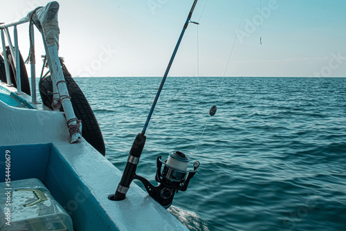 Fishing rod and reel on a boat ready for sea fishing on a sunny day