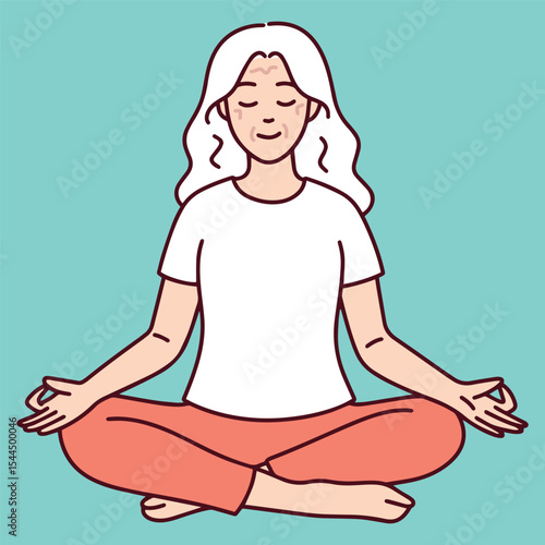 Senior woman sits calmly in lotus position with closed eyes, focusing on breathing and mindfulness as part of daily yoga or wellness routine