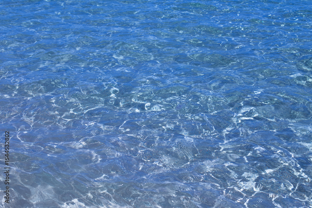 Obraz premium Surface of Clear Deep Blue Red Sea Water with Sunlight Reflections and Underwater Ripples