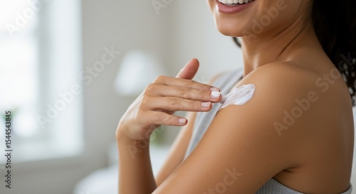 Wallpaper Mural Woman applying moisturizer to her shoulder in a skincare routine Torontodigital.ca