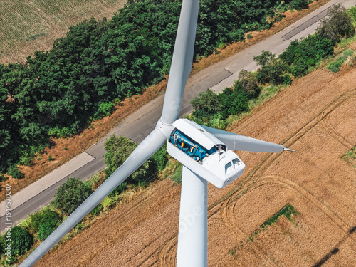 Bilde på lerret High-altitude repair work on modern wind turbine in rural field