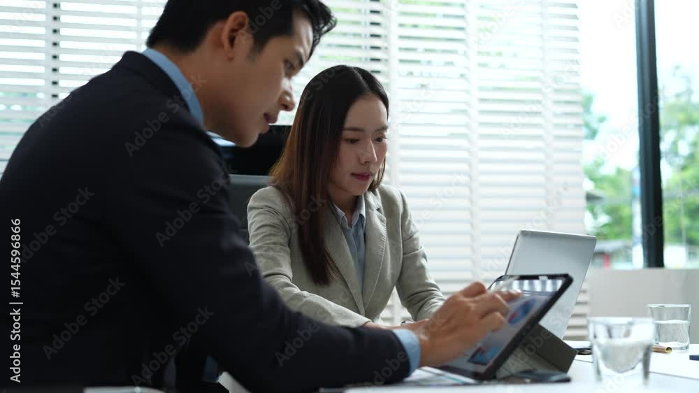 Professionals collaborate on project analysis with financial graphs. Strategic teamwork and insights drive company growth and success.