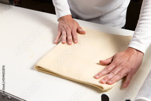 Pastry chef makes puff pastry.