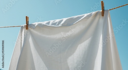 青空の下 白く輝くシーツ 清潔感漂う 洗濯物 陽光浴びて ふわふわと乾く. AI Generated