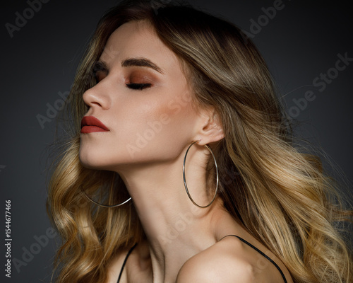 Beauty portrait of young beautiful woman against dark grey background