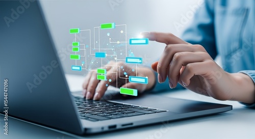Woman using laptop to manage digital workflow chart