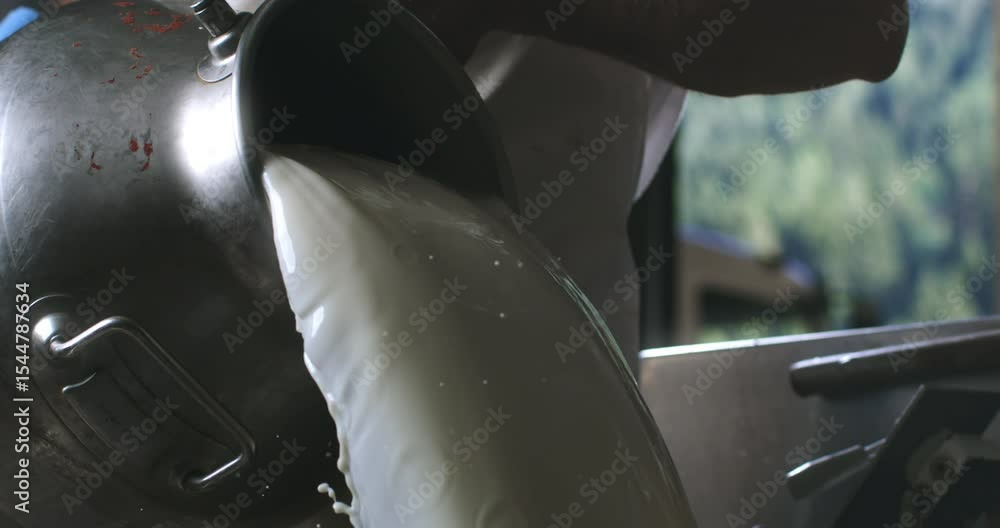 Cinematic Super slow motion macro of artisan cheesemaker is adding fresh bio eco milk during traditional cheese making process at cheese production creamery dairy factory at 1000 fps.