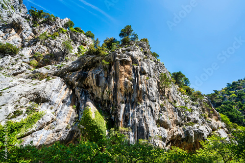 Fotografie Sheer limestone cliff in Agali Gorge sunlight
