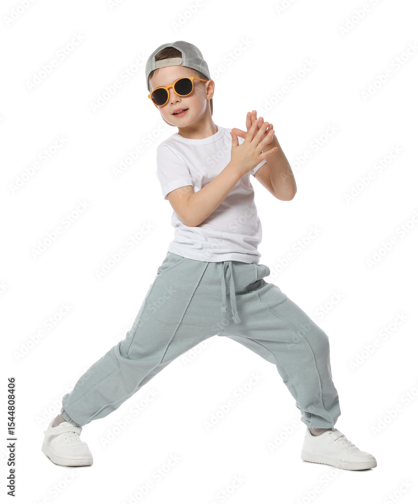 Happy little boy in sunglasses and baseball hat dancing on white background Happy little boy in sunglasses and baseball hat dancing on white background