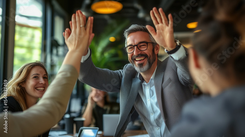 a happy business team high-fiving after success