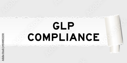 Ripped gray paper background that have word GLP (Abbreviation of Good laboratory practice) compliance under torn part