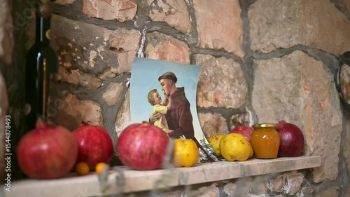 Traditional Mediterranean Home Interior with Icon of Saint Anthony, Pomegranates, Dried Lavender and Homemade Sweets on White Linen