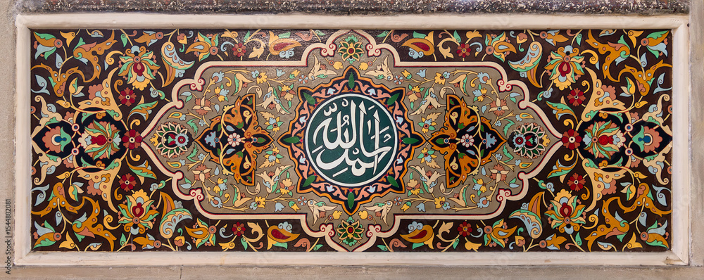 Juma Mosque in Baku, Azerbaijan, adorned with intricate floral motifs that enhance the spiritual ambiance. A captivating calligraphy mediating the structure, conveying the message of: Thank God