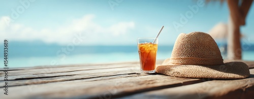 Summer holiday and vacation background with straw hat Refreshing iced tea on a sunny beach table.