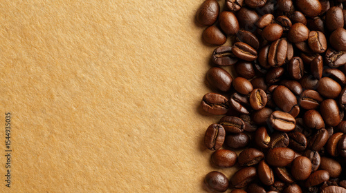 Roasted coffee beans on brown paper background with copy space
