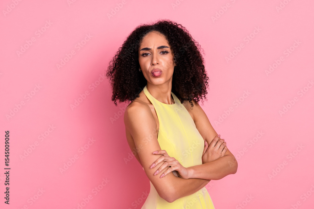 Young fashionable woman posing in a yellow dress against a pink background, showcasing charm, style, and confidence Young fashionable woman posing in a yellow dress against a pink background, showcasing charm, style, and confidence