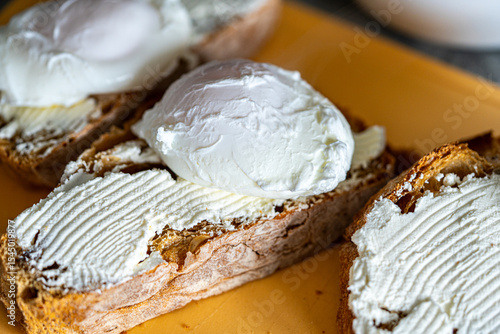 Bread toast is smeared with cottage cheese cream. Close-up.