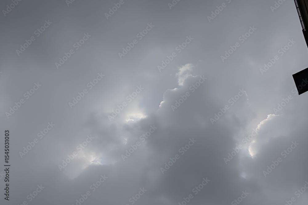 Overcast sky with patches of light breaking through grey clouds Overcast sky with patches of light breaking through grey clouds