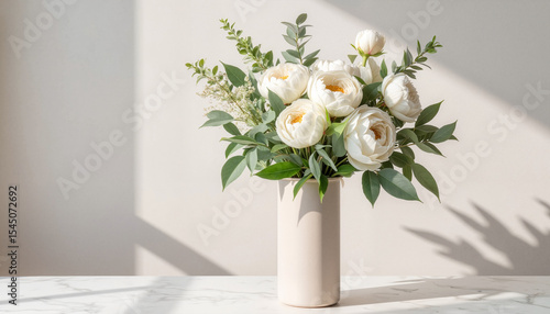 Elegant White Peonies and Greenery in a Vase with Sunlight and Shadows