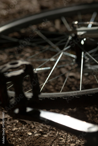 Wallpaper Mural This image shows a detailed closeup of a bicycle wheel resting on the ground, highlighting its intricate components and design features Torontodigital.ca