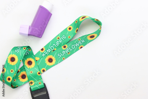Hidden disability lanyard with a asthma device in a light background