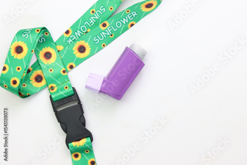 Hidden disability lanyard with a asthma device in a light background
