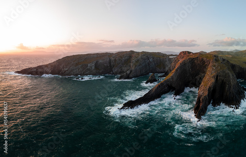 Aerial views of beautiful coastal rocky outcrops at sunset and their drama