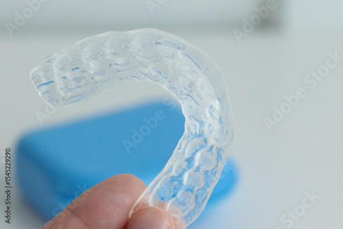 Dental whitening trays and gel applicator on white background