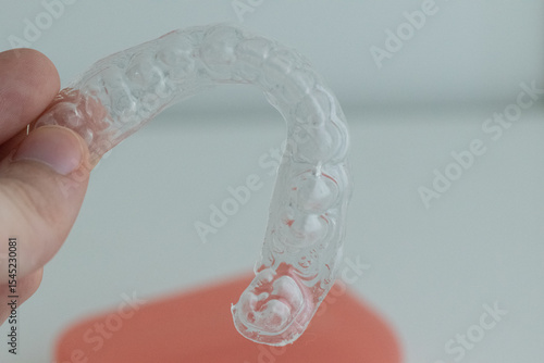 Dental whitening trays and gel applicator on white background